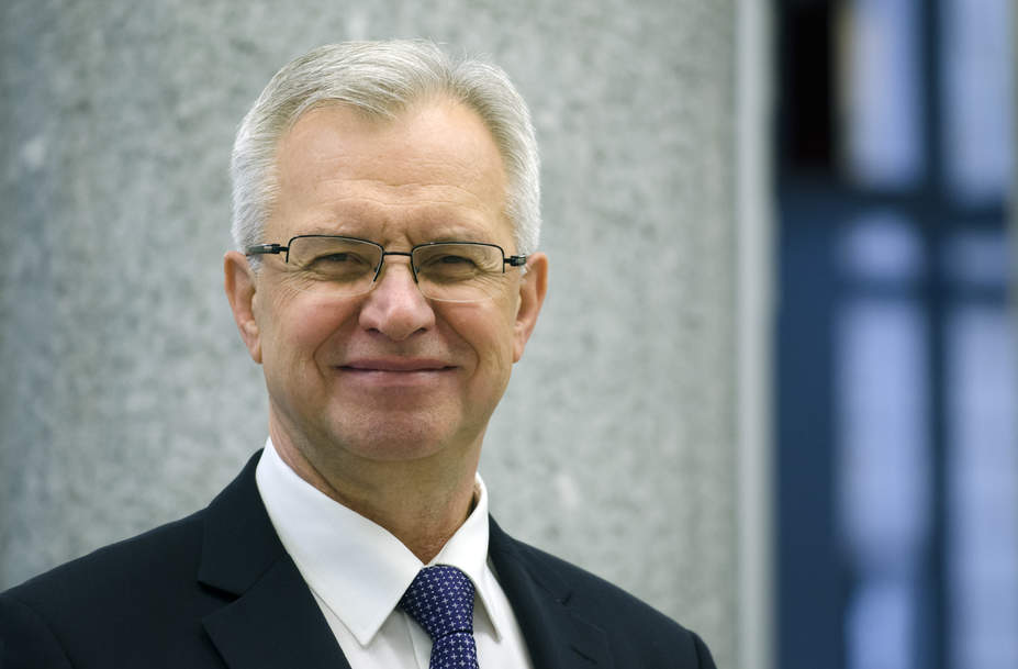 Krzysztof Michałkiewicz president of the board of PFRON on a gray background 