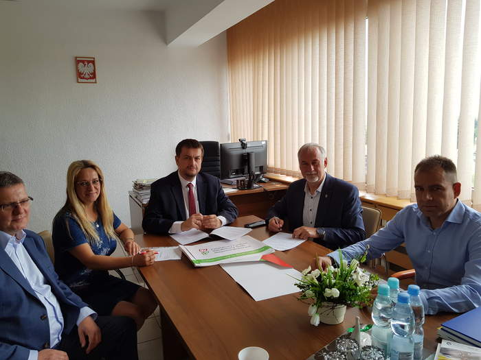 Pokaż zdjęcie: Starosta, Wicestarosta i Skarbnik Powiatu Strzelecko-Drezdencki oraz Dyrektor Oddziału wraz z pracownikiem Oddziału przy stole podpisują umowę