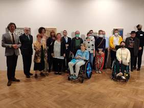 Pokaż zdjęcie: Na zdjęciu Laureaci konkursu oraz członkowie jury, przedstawiciele Fundacji Sztuki  Osób Niepełnosprawnych i Muzeum Narodowego. Wszyscy pozują na tle obrazów