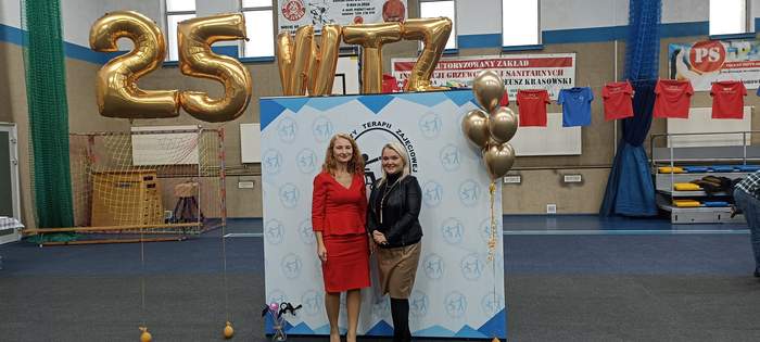 Pokaż zdjęcie: Dyrektor Oddziału Lubuskiego PFRON oraz Kierownik WTZ na tle ścianki promocyjnej 25-lecia WTZ