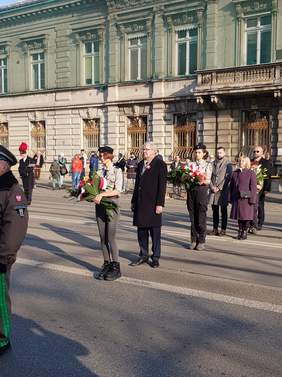 Pokaż zdjęcie: na zdjęciu ulica piotrkowska, na której odbywają się uroczystości Narodowego Święta Niepodległości. Przedstawiciele urzędów składają kwiaty i wieńce pod Grobem Nieznanego Żołnierza 