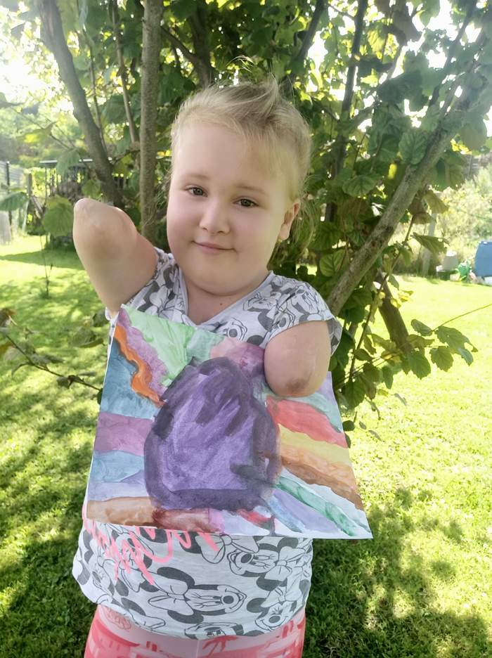 Pokaż zdjęcie: I miejsce (110 głosów) Maria Magdalena Kozdra – nagroda: praca namalowana przez Stanisława Kmiecika. Na zdjęciu dziewczynka - autorka wraz ze swoją pracą.