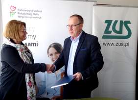 Uścisk dłoni po podpisaniu umowy Aleksandry Gierej - dyrektor Oddziału Kujawsko-Pomorskiego PFRON i  Mariusza Jaroniewskiego - dyrektora Oddziału ZUS w Bydgoszczy 