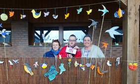 Prace uczestników oraz zwiedzający wystawę: od lwej stoją - Pani Alicja Bogacka, autor prac oraz jego mama