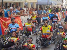 Pokaż zdjęcie: Uczestnicy wszystkich biegów w ramach PFRON CUP. Za barierką oddzielającą, stoją zebrani widzowie..