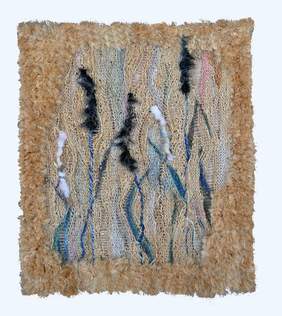 Pokaż zdjęcie: Ręcznie wykonana tkanina artystyczna w naturalnych odcieniach beżu, brązu i błękitu, z wyraźnie widoczną strukturą splotów. Praca ma nieregularne, falujące wzory z dodatkiem czarnych i białych włókien, które nadają jej dynamiczny charakter. Całość otoczona jest puszystą, beżową ramą z tekstylnego materiału, co podkreśla organiczny styl kompozycji.