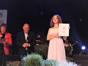 Pokaż zdjęcie: Na scenie stoją: zdobywczyni Grand Prix Festiwalu - Anastasiia Tarnavska oraz przewodniczący jury - Andrzej Frajndt i organizator - Mirosław Satora - Prezes Fundacji PRO OMNIBUS 