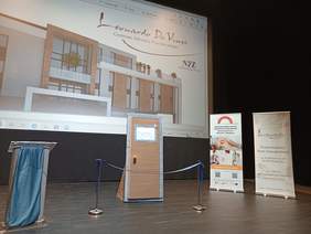 Pokaż zdjęcie: Otwarcie Centrum Zdrowia Psychicznego w Wieliczce - scena, na której stoją drzwi przewiązane wstęgą.