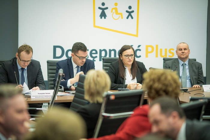 Pokaż zdjęcie: Cztery osoby siedzące za stołem prezydialnym