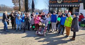 Pokaż zdjęcie: Liczna grupa pozuje na tle food truck`a Frytek Belgijskich 