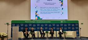 Pokaż zdjęcie: Na scenie siedzą od lewej Pan Krzysztof Czechowski Koordynator ds. dostępności ZUS, Pani Anna Wandzel Dyrektor Oddziału Mazowieckiego PFRON, Pan Paweł Chorąży Dyrektor Zarządzający Pionem Funduszy Europejskich oraz Pani Katarzyna Rzehak Specjalistka projektowania uniwersalnego i Pan Kamil Kowalski Dyrektor Integracja LAB. W tle slajd prezentacji opisujący przedstawicieli panelu dyskusyjnego dotyczący Narzędzi wsparcia w obszarze wdrażania dostępności, w lewym górnym rogu logo ZUS, na dole slajdu logo partnerów.