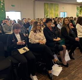 Publiczność siedząca w sali konferencyjnej hotelu Victoria w Lublinie. Uczestnicy III Ogólnopolskiej Konferencji „Oswoić skoliozę” zajmują rzędy krzeseł i słuchają prelekcji.