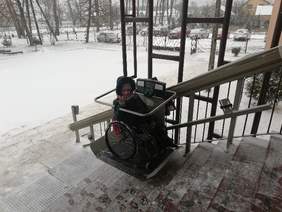 Pokaż zdjęcie: Dziewczyna na wózku na platformie przyschodowej