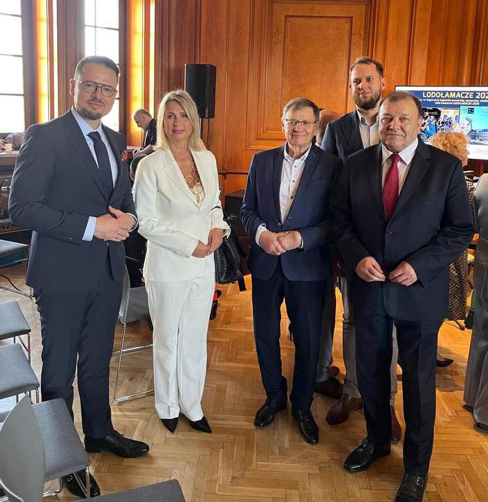 Cztery osoby pozują do zdjęcia w reprezentacyjnej, drewnianej sali Centrum Kultury „Zamek” w Poznaniu podczas Gali Lodołamacze 2026. W tle widoczny ekran z informacją o konkursie.