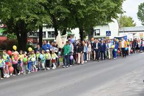 Pokaż zdjęcie: Uczestnicy marszu trzymają w ręku kolorowe balony. 