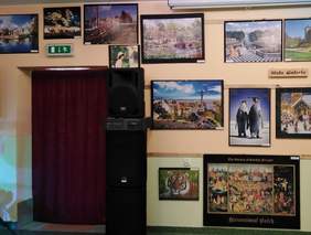 Pokaż zdjęcie: Wystawa obrazów wykonanych z puzzli.Obrazy wiszą  na ścianie DPS Lublin